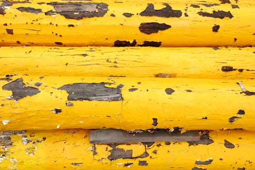 Pile of Old Yellow Wood Poles.