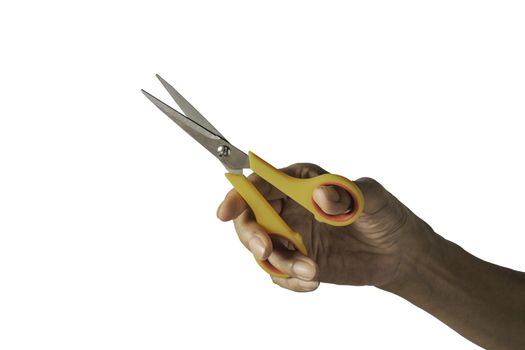Hand holding a scissors with yellow plastic handle and clipping 