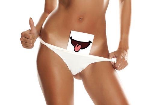 Woman with panties cowers her vagina with smile drawn on sheet