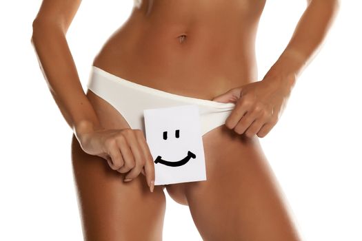 Woman with panties cowers her vagina with exclamation mark drawn