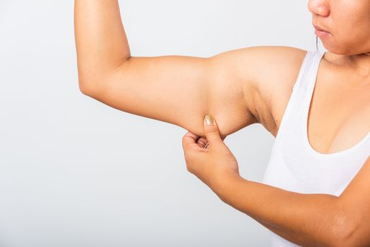 woman pulling excess fat on her under arm, problem armpit skin