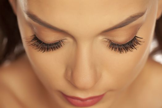 woman with closed eyes and eyelash extension