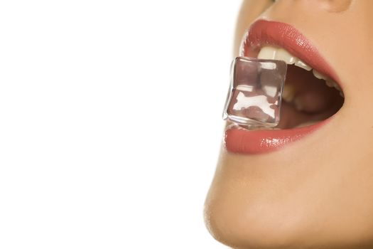 woman holding ice cube in her mouth