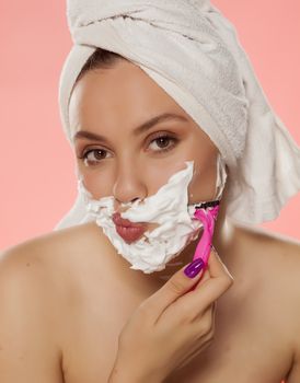 woman shaving her face