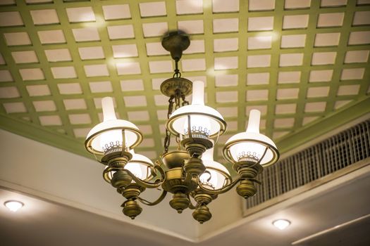 Old lamps with glass structure on ceiling in ballroom