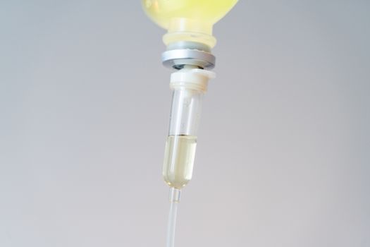 Drop of Saline Solution,IV drip chamber, IV tubing hanging on a 
