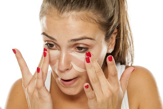 women applied concealer under the eyes