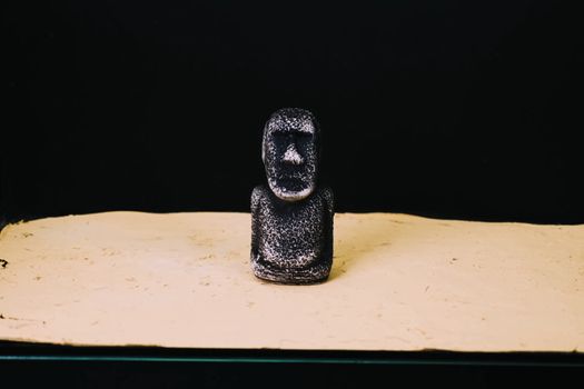mock statue from Easter Island. A stone man on the sand.