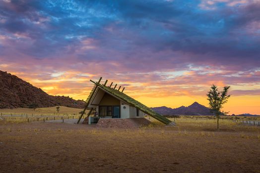 Sunrise above a small hut in a desert lodge near Sossusvlei in Namibia