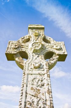 Celtic carved stone cross against a sky background 