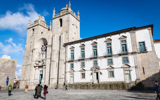  People walking in front of Porto Cathedral, Portugal