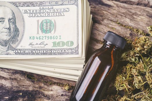 dried medical marijuana with CBD  THC extract and dollar bill