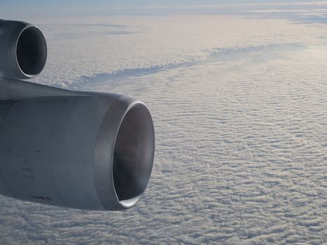 Two jet engines above cloud