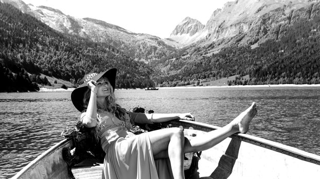 romantic scene with female model with long blond hair on a boat. Life style Shooting of a girl
