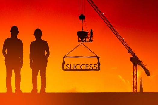 Silhouette of the success of the construction worker, the concept of success of the work is tired than to accomplish it, which has been difficult.