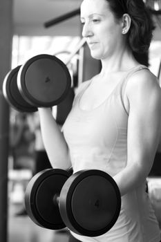 Thin thirties woman doing exercise in the gym