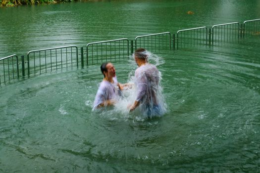 Pilgrims baptizing in the Jordan River