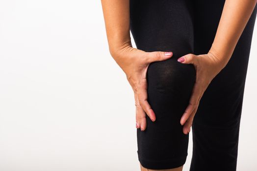 Woman pain knee and she uses hand joint hold knee agony