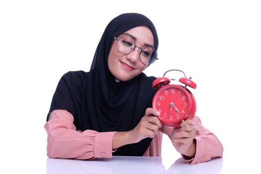 Asian woman hold a alarm clock