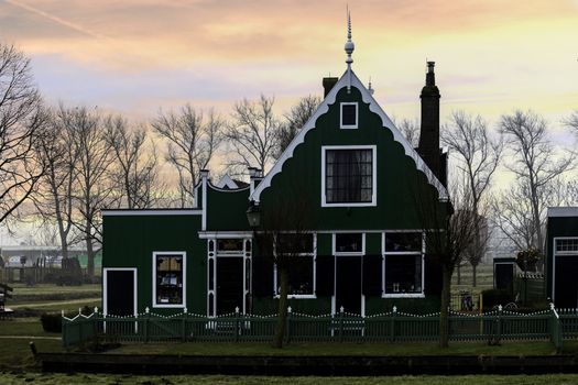 Beaucoutif typical Dutch wooden houses architecture along the calm canal of Zaanse Schans located at the North of Amsterdam, Netherlands
