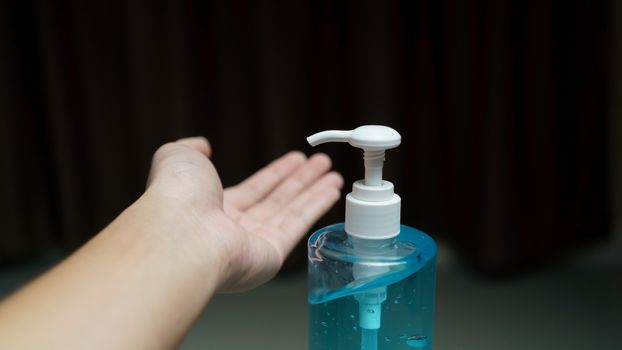 Man cleaning his hands with sanitizer liquid antibacterial gel, 