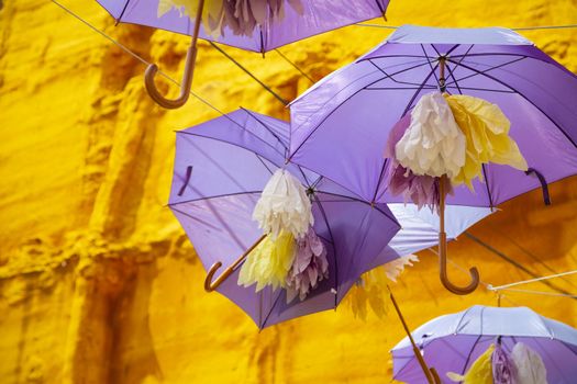 Purple umbrellas hanged in main street in Brihuega, Guadalajara.
