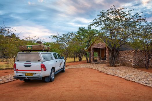 4x4 suv car with a roof tent parks at the Kaoko Bush Lodge near Etosha, Namibia