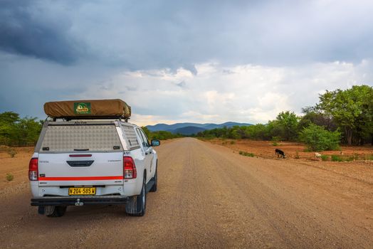 4x4 suv car equipped with a roof tent driving through Kunene Region in Namibia