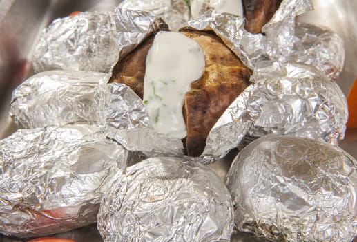 Baked potatoes in foil at a buffet