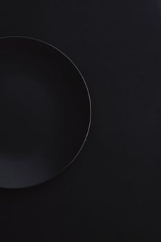 Empty plates on black background, premium dishware for holiday dinner, minimalistic design and diet