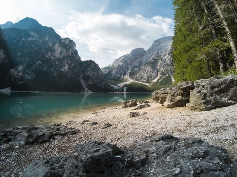 Amazing view of Braies Lake. Lago di Braies with summer forest and mountains reflected in surface lake water Dolomites Alps, Italy, Europe. Captured on Gopro hero 5 hero5.