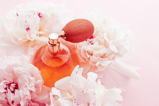 Vintage fragrance bottle as luxe perfume product on background of peony flowers, parfum ad and beauty branding