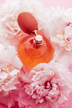 Vintage fragrance bottle as luxe perfume product on background of peony flowers, parfum ad and beauty branding