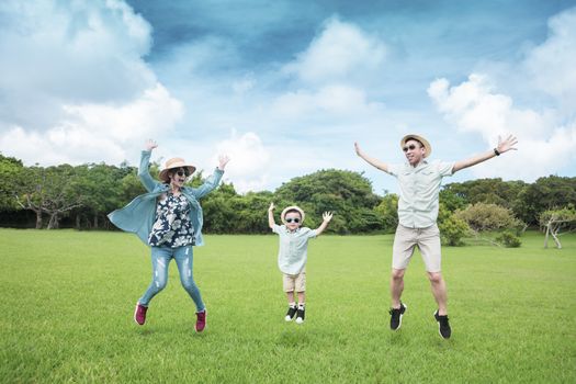 happy  family jumping on the grass and enjoy summer vacation