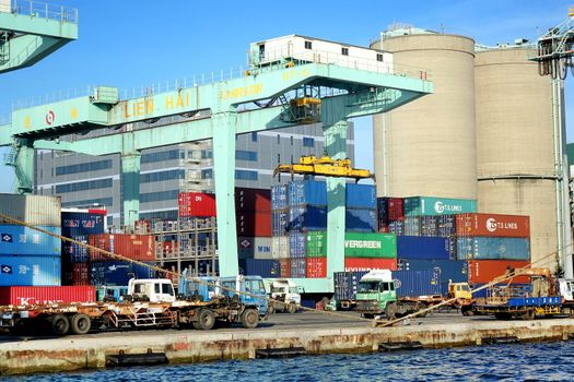 KAOHSIUNG, TAIWAN -- MAY 26, 2018: A shipping container is being loaded in the busy port of Kaohsiung, a major trading hub for Taiwan.