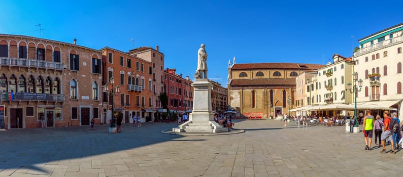 Venice, Italy - June 20, 2017: Campo Santo Stefano square with Nicolo Tommaseo monument and Santo Stefano church. Unrecognizable people are walking down the square.