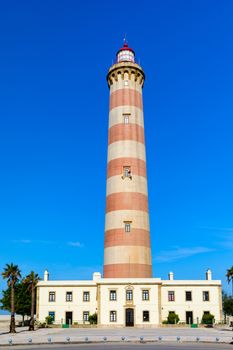 Lighthouse of Praia da Barra during the day, with a clear blue s
