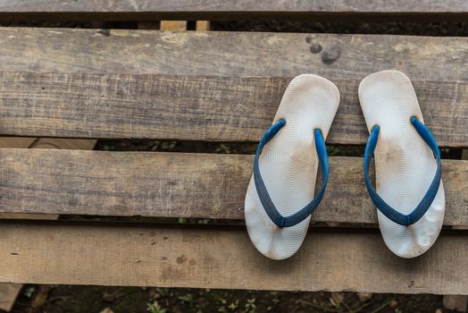 Sandal or flip-flop blue color on wooden staircase