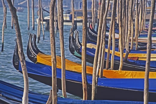View accros the Venetian Lagoon to Gondolos on their mooring poles