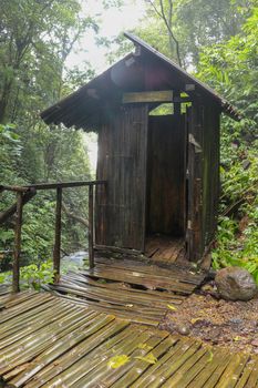 Wooden cabin with changing rooms in tropical jungle, near Spray waterfall, Banyumala. Bamboo changing room on wooden stilts for visitors in Bali island, Indonesia. Best background for aour project.