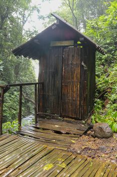 Wooden cabin with changing rooms in tropical jungle, near Spray waterfall, Banyumala. Bamboo changing room on wooden stilts for visitors in Bali island, Indonesia. Best background for aour project.