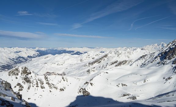 Panoramic view down snow covered valley in alpine mountain range