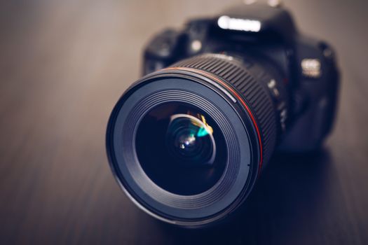 Digital camera or DSLR with camera lens with lense reflections. 