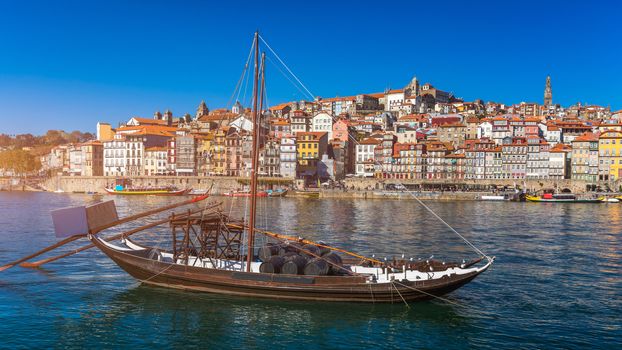 Oporto or Porto city skyline, Douro river, traditional boats and