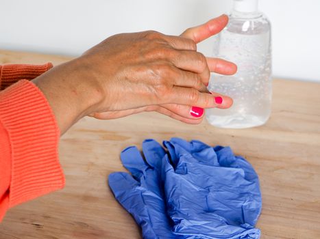 close up of  woman hands while cleaning and sanitizing  herself 