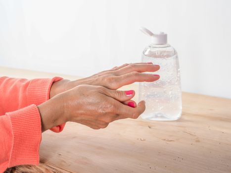 close up of  woman hands while cleaning and sanitizing  herself 