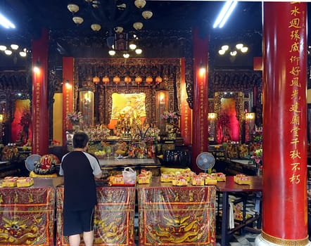 Saying Prayers at the Altar of a Temple in Taiwan