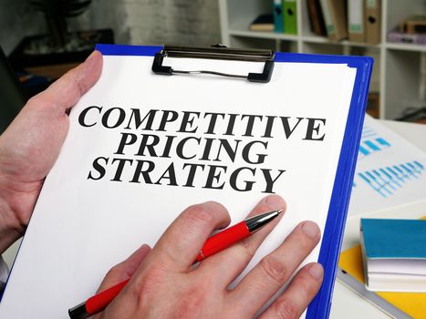 A Businessman reads competitive pricing strategy report.