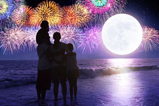 Happy family looking at holiday fireworks in sky