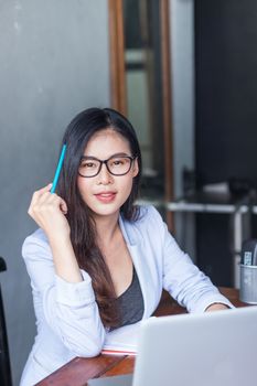 Business women wear glasses Beautiful asians Have fun in the off